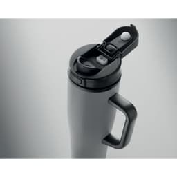 A drink bottle in matte black with a handle and a flip-top lid featuring a button mechanism and a small opening.