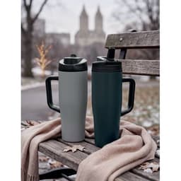 A drink bottle set featuring a grey and a navy bottle, both with black lids and handles, resting on a bench with a scarf.