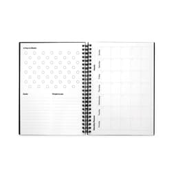 An A5 infinite diary with a spiral binding, featuring blank pages for planning, goals, and a monthly calendar layout.