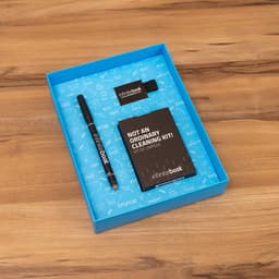 A blue box containing an Infinitebook planner, a black marker, a ballpoint holder, and a cleaning kit.