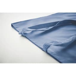 A blue tote bag with handles, featuring a smooth fabric design. The bag rests flat on a light background.