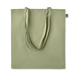A tote bag in a soft green colour with long handles and a small tag.