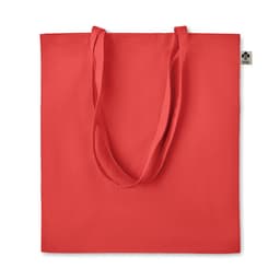 A red tote bag with long handles and a tag, featuring a simple, solid colour design.