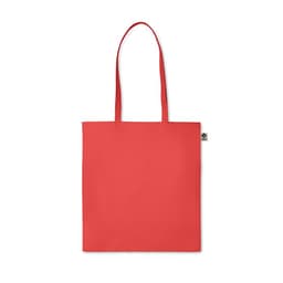 A red tote bag with two handles, featuring a small logo label on one side.