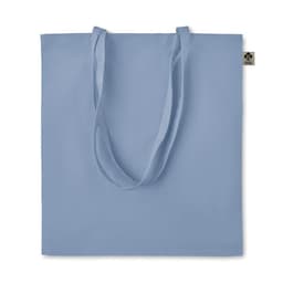 A tote bag in light blue with long handles and a branding tag on the side.