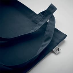 A navy blue tote bag with two handles and a small logo tag on the side.