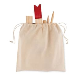 A drawstring bag in a neutral colour containing various wooden tools and a red spatula.