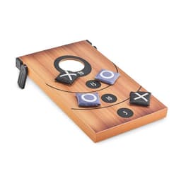 A bean bag toss game on a wooden board, featuring holes with varying point values and black and white bags for playing.