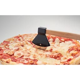 A pizza cutter with a black handle slicing through a cheese pizza on a wooden board.
