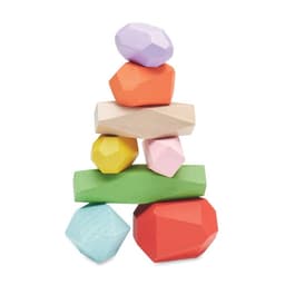 A stack of colourful, geometric-shaped wooden blocks in shades of pink, orange, yellow, green, purple, and blue.