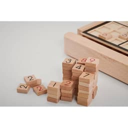 A wooden Sudoku game set with numbered tiles stacked in groups. The game board is partially visible.