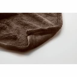 A soft, brown throw blanket with a textured finish, featuring a neatly folded edge.