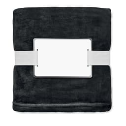 A plush black blanket neatly folded and secured with a white strap, featuring a blank label.