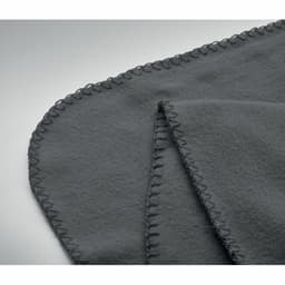 A grey fleece blanket with stitched edges, folded to display its soft texture and neat finish.
