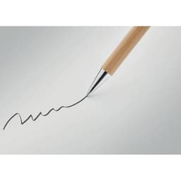 A pen with a wooden barrel and a silver tip, drawing a wavy line on a smooth surface.
