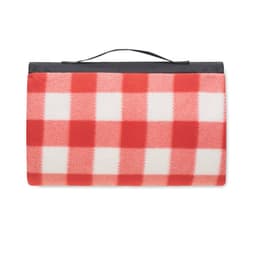A picnic blanket with a red and white checkered pattern, featuring a black carrying handle on top.