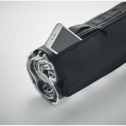 A rolled grey blanket with a black zipper bag, featuring a smartphone partially visible inside the pocket.