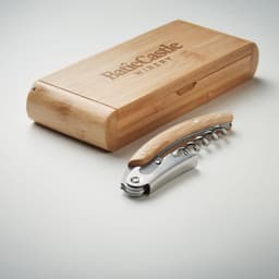 A corkscrew with a wooden handle, presented in a bamboo box featuring a logo. The box is light brown in colour.