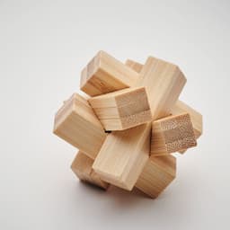 A wooden puzzle featuring interlocking pieces, showcasing a natural wood finish with various shapes.
