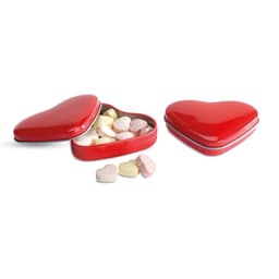 A heart-shaped red tin with a lid, containing pastel-coloured heart-shaped sweets.