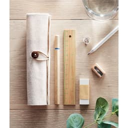 A pencil case with a wooden ruler, a pencil, a pen, an eraser, a sharpener, and a clear button on a wooden surface.