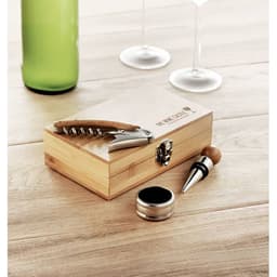 A drink bottle in shades of green alongside a wooden box containing a corkscrew, stopper, and accessories.