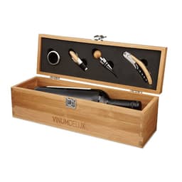 A drink bottle is placed inside a wooden box with a corkscrew, pourer, and stopper in a black velvet lining.