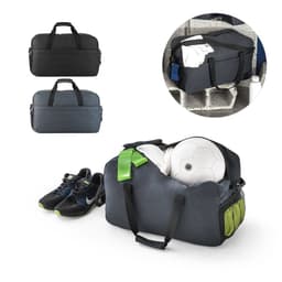 A duffle bag in dark grey and green, containing shoes, a soccer ball, and clothes, with a logo.