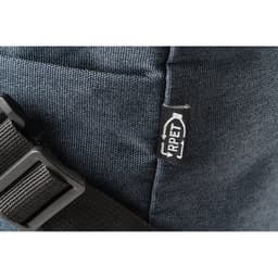 A close-up of a dark blue recycled polyester sports bag with a strap and a small tag featuring a logo.