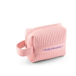 A pink quilted handbag with a zipper and a side handle, featuring a branding label.