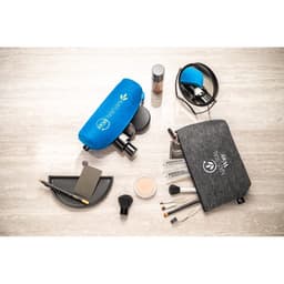 A grey multi-purpose bag made of recycled felt with a blue accessory case, surrounded by makeup items and tools.