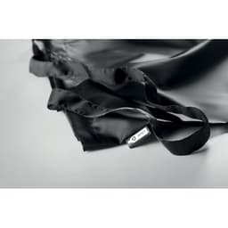 A black tote bag with long handles and a small branded tag. The fabric appears soft and smooth.