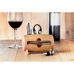 A drink bottle holder made of wood with essential wine tools, including a corkscrew, foil cutter, and stopper.