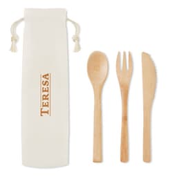 A reusable bamboo cutlery set with a spoon, fork, and knife, packaged in a natural fabric pouch.