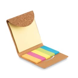 A cork notebook with a flap, featuring yellow sticky notes and five coloured sticky tabs in pink, blue, and green.