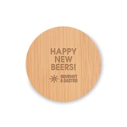 A round bamboo coaster featuring an engraved design with the text "Happy New Beers!" and a brand logo.