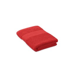 A folded red towel featuring textured lines, with a soft, plush appearance. It has a branded logo visible.