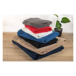 A stack of six soft towels in grey, red, white, black, and beige, with a potted plant in the background.