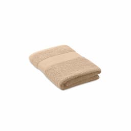 A towel in a light beige colour, neatly folded with a textured stripe design. It has a simple, classic appearance.