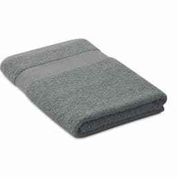 A grey towel folded neatly, featuring a textured stripe detail. It has a soft, plush appearance.