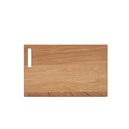 A wooden cutting board in light oak with a built-in handle on one side. It has a smooth surface and natural finish.