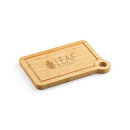 A bamboo cutting board with a built-in corner handle and a logo, featuring a natural finish.