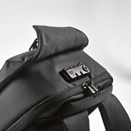 A black backpack features a TSA lock and anticut fabric, with a zippered compartment and padded shoulder strap.