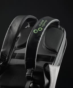 A black backpack with padded shoulder straps and a logo on the top. The material appears durable and stylish.
