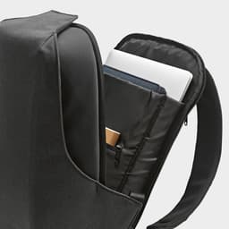 A black backpack with an open compartment, showcasing a padded section for a laptop and additional pockets.