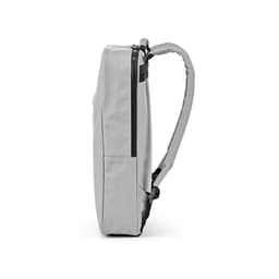 A grey backpack with a slim design, featuring a zippered pocket and a single padded strap.