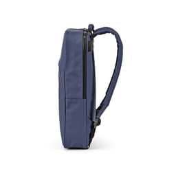 A navy blue backpack with a slim profile, featuring a zippered compartment and a logo on the side.