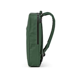 A green backpack with a slim profile, featuring adjustable straps and a zippered closure. It has a logo.
