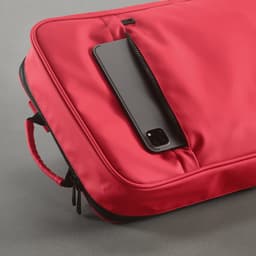 A red backpack featuring a sleek design and a zippered pocket with a smartphone resting inside.