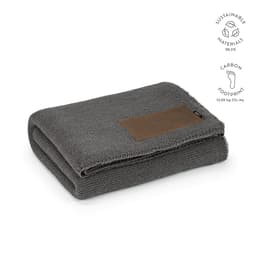 A grey blanket made from rPET and wool blend, featuring a customisable patch and a logo.